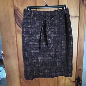 Women’s plaid skirt with tie at waist.